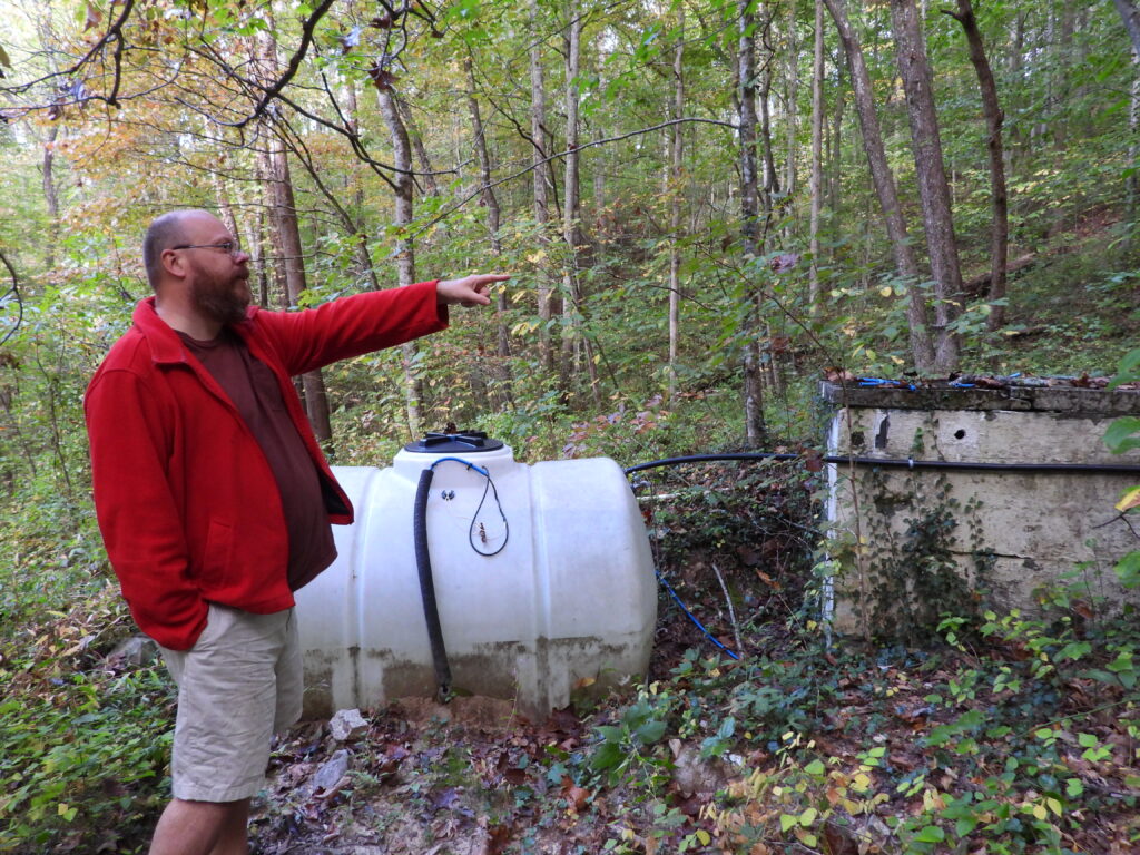 Water tank below a spring